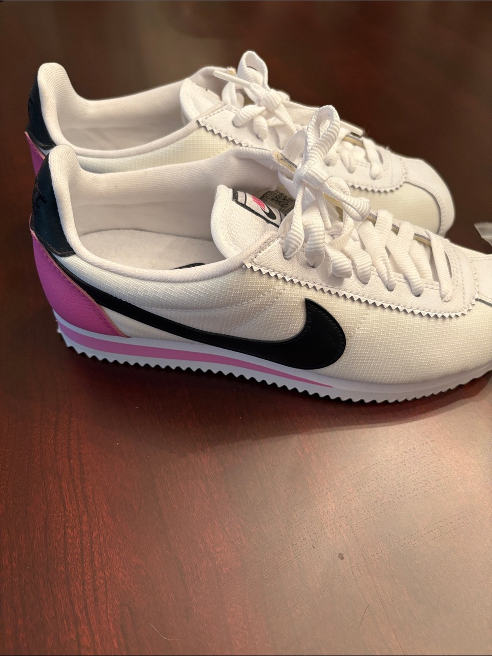 Nike Women's White Sneakers with Black Swoosh and Pink Accents